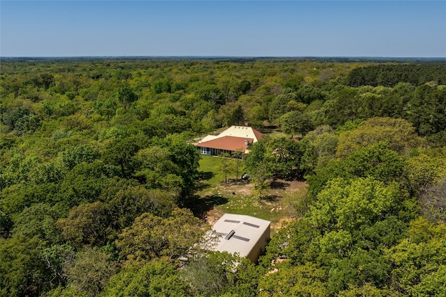 drone / aerial view with a wooded view