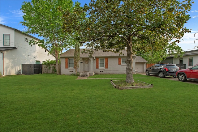 back of property featuring a garage, a lawn, and fence