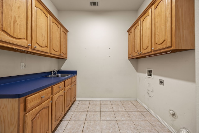 560 Glenn Ln, Red Oak, TX 75154 - clothes washing area with light tile patterned floors, washer hookup, a sink, cabinet space, and electric dryer hookup