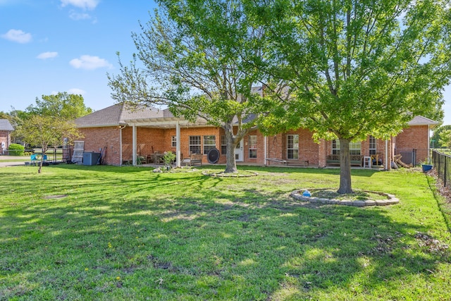 560 Glenn Ln, Red Oak, TX 75154 - back of property featuring brick siding, roof with shingles, fence, and a lawn
