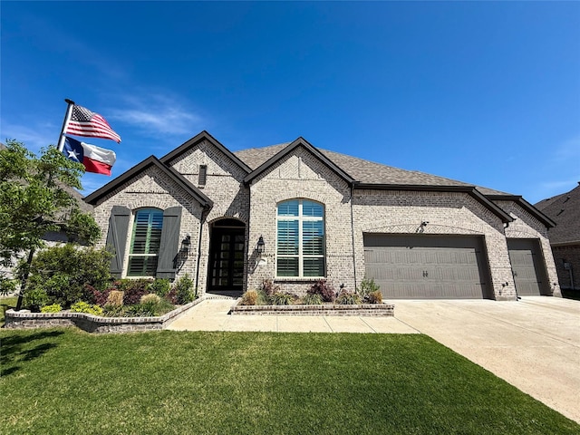 3810 Braxton Dr, Melissa, TX 75454 - french country inspired facade featuring an attached garage, brick siding, a front yard, and driveway