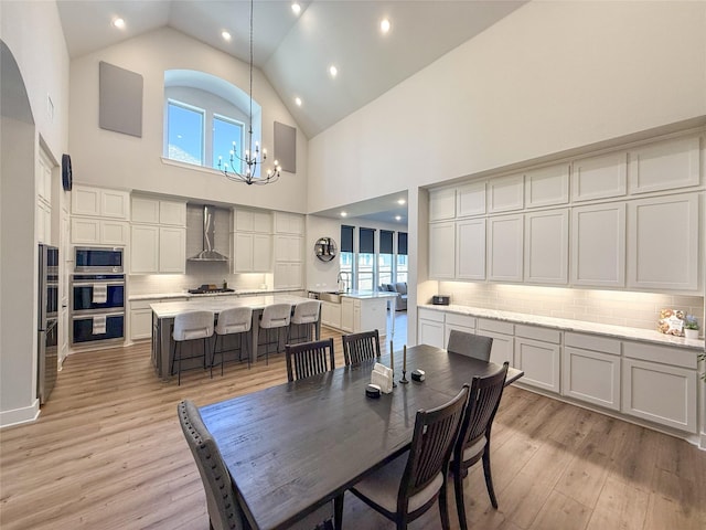 3810 Braxton Dr, Melissa, TX 75454 - dining space with a chandelier, light wood finished floors, high vaulted ceiling, and recessed lighting