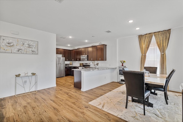 dining space with recessed lighting, visible vents, light wood finished floors, and baseboards