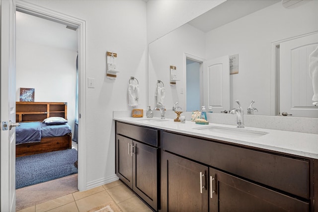 ensuite bathroom featuring double vanity, ensuite bath, tile patterned flooring, and a sink