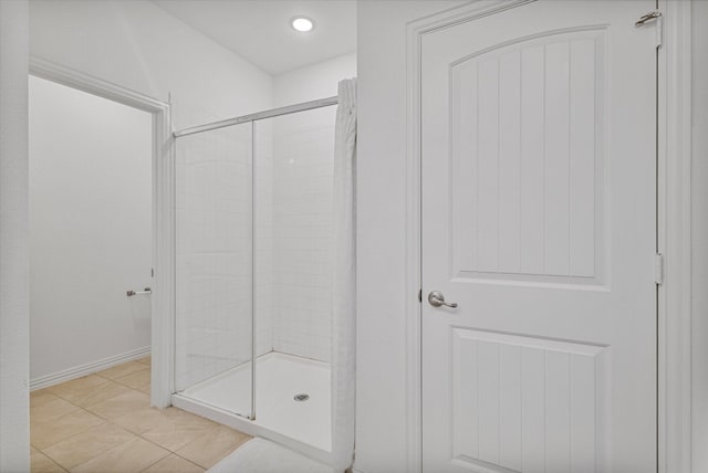 full bathroom featuring recessed lighting, baseboards, tile patterned flooring, and a shower stall