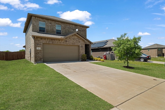 traditional-style home featuring concrete driveway, an attached garage, fence, a front yard, and brick siding