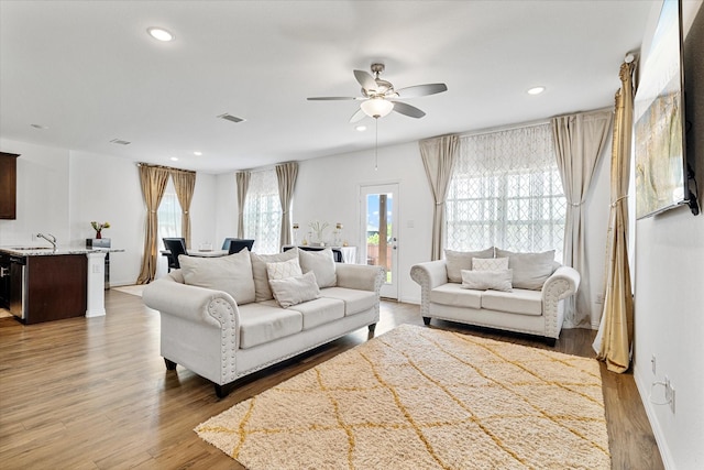 living room featuring recessed lighting, wood finished floors, visible vents, and a ceiling fan