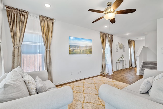 living area with stairway, wood finished floors, recessed lighting, and ceiling fan