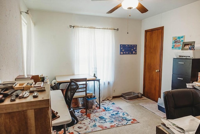 office with a ceiling fan and carpet