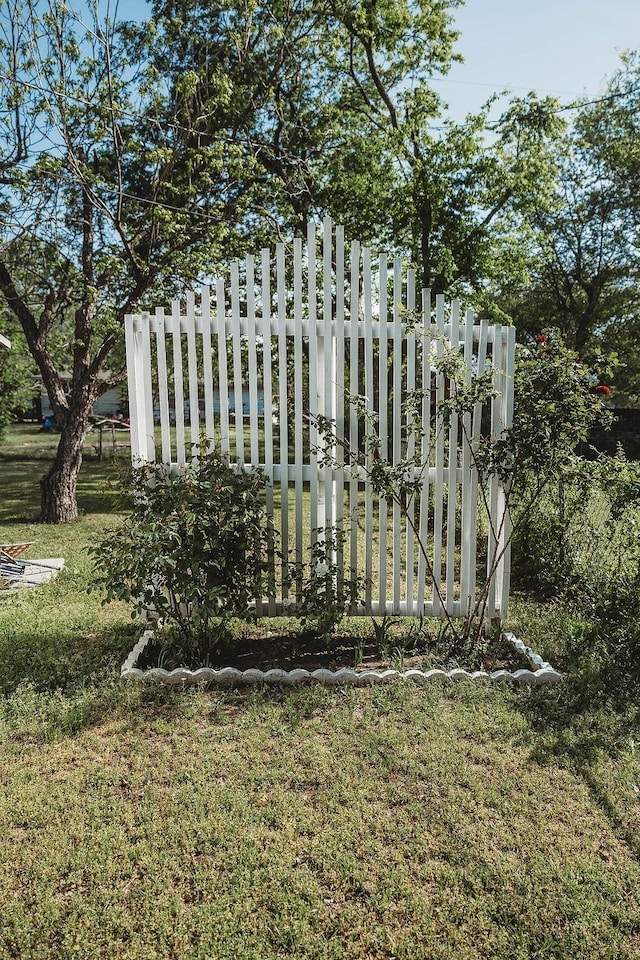 view of gate with a lawn