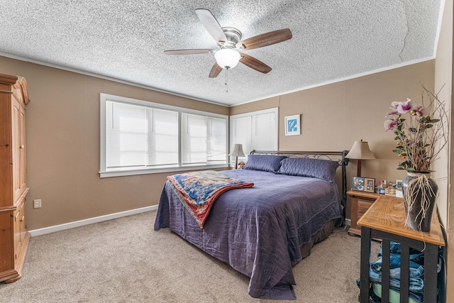 carpeted bedroom featuring a ceiling fan, baseboards, a textured ceiling, and a closet
