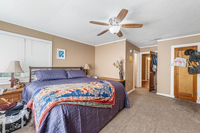 bedroom with a textured ceiling, visible vents, light colored carpet, a ceiling fan, and ornamental molding