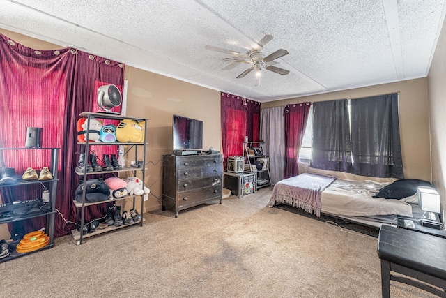 carpeted bedroom with a textured ceiling and ceiling fan