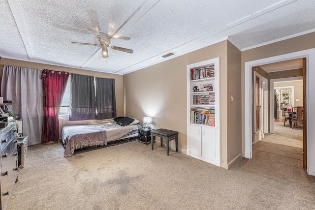 carpeted bedroom with ceiling fan, crown molding, a textured ceiling, and visible vents