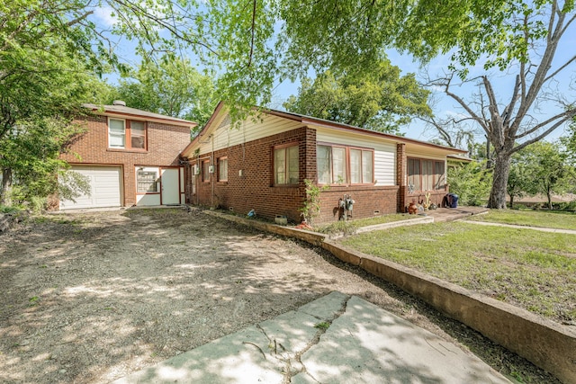 view of front of home featuring a garage, brick siding, driveway, and a front lawn