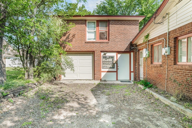 view of front of house with brick siding, driveway, and a garage