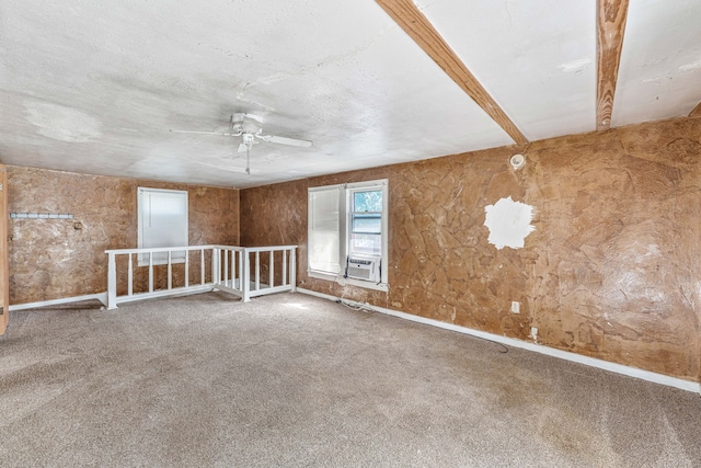 carpeted spare room with baseboards, a ceiling fan, and cooling unit