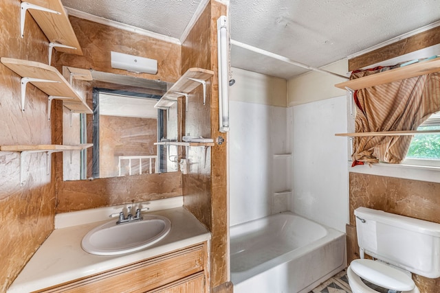 full bathroom featuring toilet, washtub / shower combination, vanity, and a textured ceiling