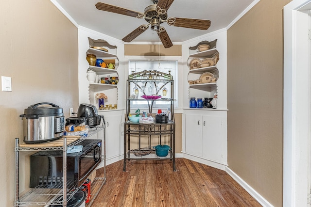 dining space with ceiling fan, baseboards, ornamental molding, and wood finished floors