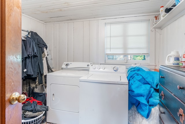 washroom with wooden ceiling, washer and clothes dryer, and laundry area