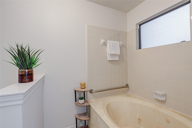 full bath with a textured ceiling and a tub with jets