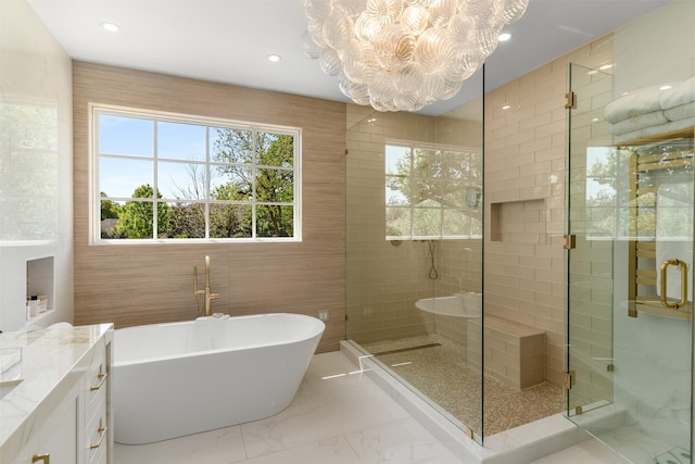 bathroom featuring recessed lighting, marble finish floor, a chandelier, a freestanding tub, and a stall shower