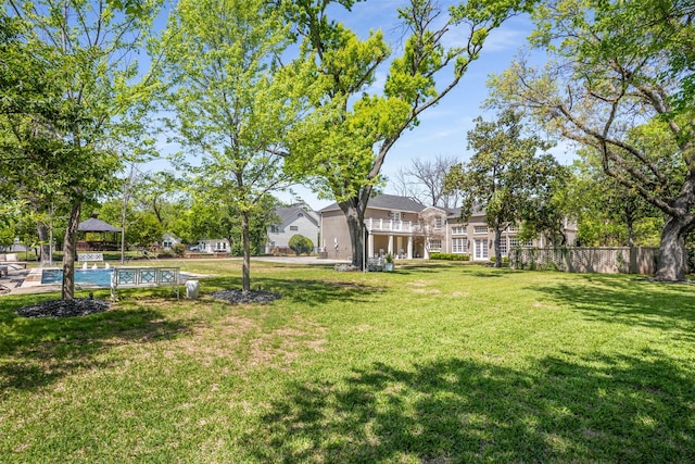 view of yard with a gazebo, a fenced in pool, and fence