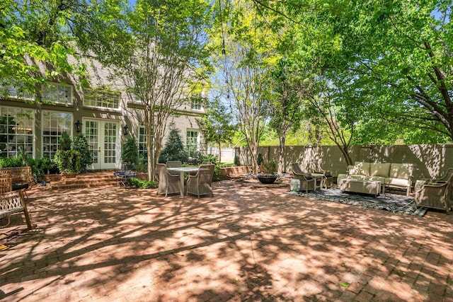 view of patio / terrace featuring fence, an outdoor hangout area, and french doors
