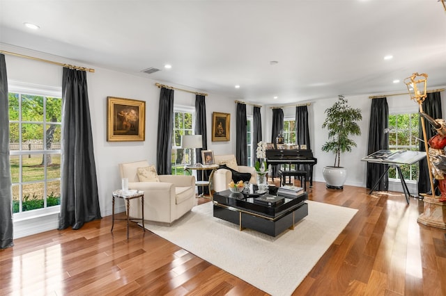 living room with recessed lighting, wood finished floors, and a wealth of natural light