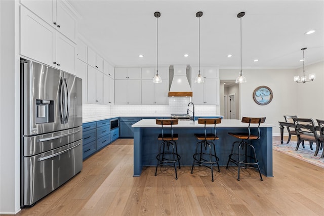 301 Wycliff Dr, Waco, TX 76633 - kitchen featuring premium range hood, backsplash, stainless steel refrigerator with ice dispenser, and a kitchen breakfast bar