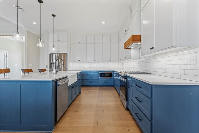 301 Wycliff Dr, Waco, TX 76633 - kitchen with blue cabinets, stainless steel appliances, white cabinets, visible vents, and light countertops