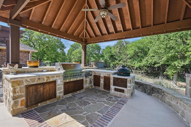 view of patio featuring a gazebo, ceiling fan, area for grilling, and a grill