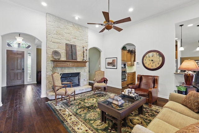 114 Deer Crossing Way, Azle, TX 76020 - living room with a ceiling fan, baseboards, arched walkways, dark wood-style flooring, and ornamental molding