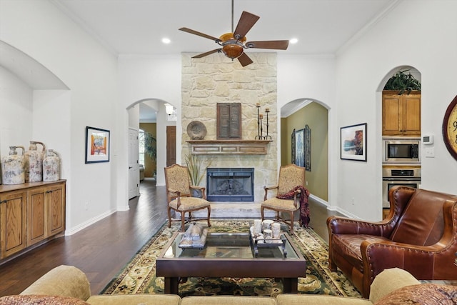 114 Deer Crossing Way, Azle, TX 76020 - living room featuring a ceiling fan, dark wood-style floors, crown molding, arched walkways, and baseboards