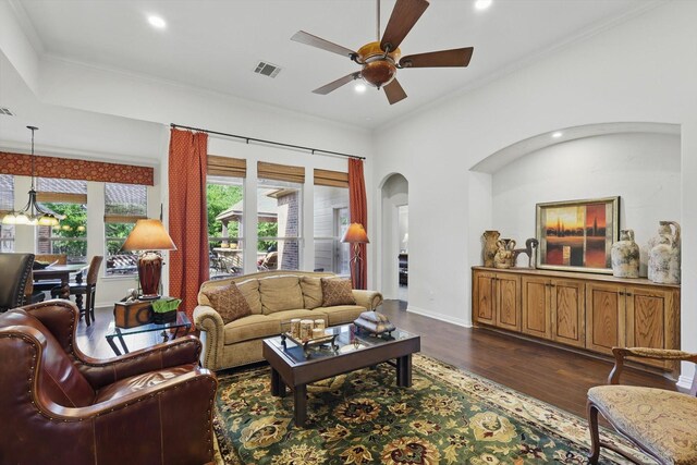 114 Deer Crossing Way, Azle, TX 76020 - living room featuring a ceiling fan, arched walkways, dark wood-style flooring, a fireplace, and crown molding