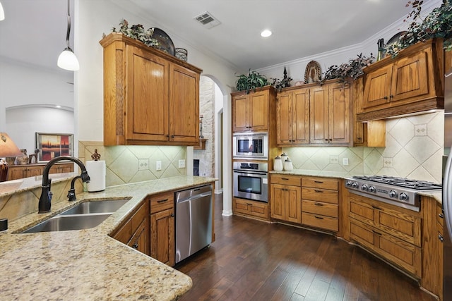 114 Deer Crossing Way, Azle, TX 76020 - kitchen with stainless steel appliances, a sink, arched walkways, light stone counters, and dark wood finished floors