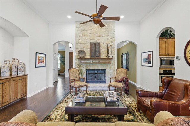 114 Deer Crossing Way, Azle, TX 76020 - kitchen with appliances with stainless steel finishes, arched walkways, light stone counters, dark wood-style flooring, and backsplash