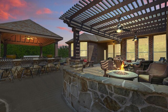 114 Deer Crossing Way, Azle, TX 76020 - back of property at dusk featuring a gazebo and brick siding