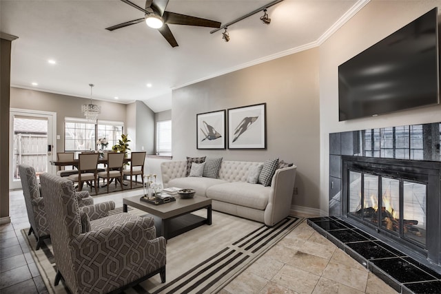 9910 Royal Ln Unit 1402, Dallas, TX 75231 - living area featuring baseboards, ceiling fan, a tile fireplace, crown molding, and track lighting