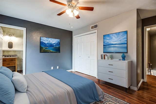 9910 Royal Ln Unit 1402, Dallas, TX 75231 - bedroom featuring dark wood-style flooring, baseboards, a ceiling fan, a closet, and ensuite bath