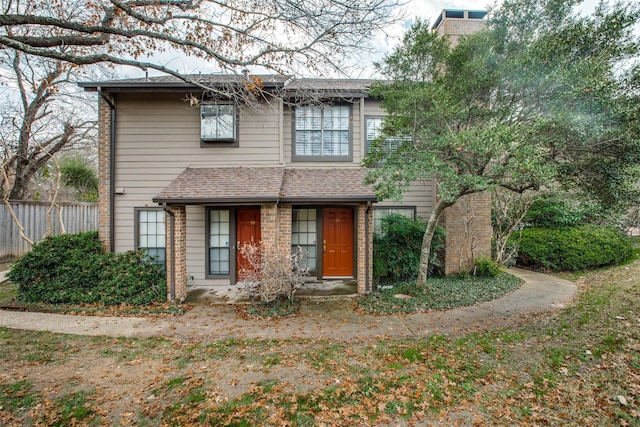 9910 Royal Ln Unit 1402, Dallas, TX 75231 - view of front facade featuring brick siding and a chimney