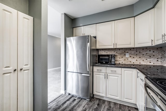 9910 Royal Ln Unit 1402, Dallas, TX 75231 - kitchen with freestanding refrigerator, dark wood-style floors, white cabinetry, and decorative backsplash