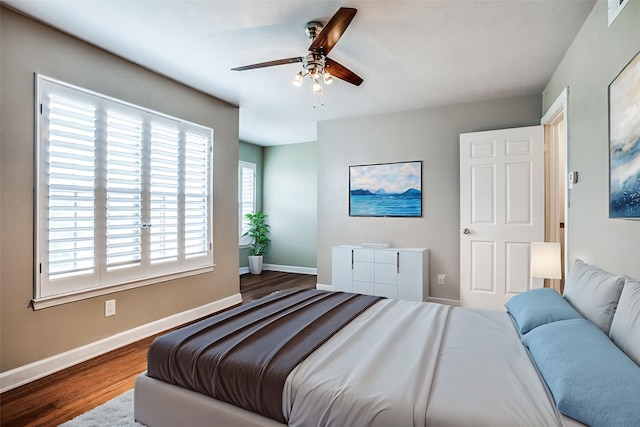 9910 Royal Ln Unit 1402, Dallas, TX 75231 - bedroom with wood finished floors, baseboards, and ceiling fan