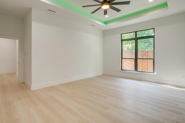 2229 Varsity Dr, Grand Prairie, TX 75051 - empty room with a tray ceiling, light wood-type flooring, visible vents, recessed lighting, and ceiling fan