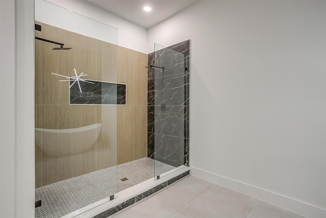 2229 Varsity Dr, Grand Prairie, TX 75051 - bathroom with baseboards, tile patterned flooring, and a tile shower