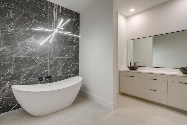 2229 Varsity Dr, Grand Prairie, TX 75051 - bathroom with recessed lighting, tile patterned floors, a freestanding bath, vanity, and tile walls