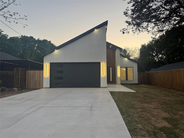 2229 Varsity Dr, Grand Prairie, TX 75051 - modern home with an attached garage, a front lawn, concrete driveway, and fence