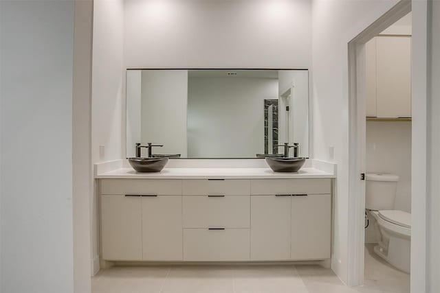 2229 Varsity Dr, Grand Prairie, TX 75051 - full bath with double vanity, tile patterned flooring, toilet, and a sink