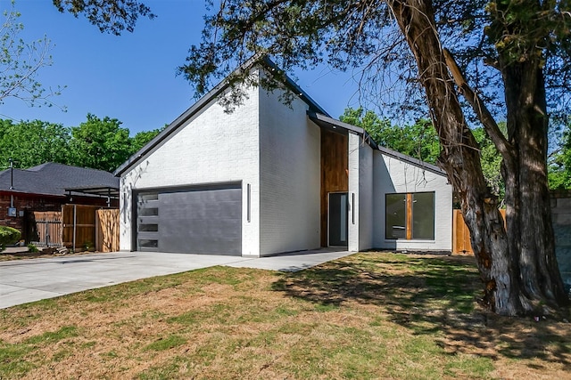 2229 Varsity Dr, Grand Prairie, TX 75051 - view of front of house featuring fence, a front lawn, driveway, and brick siding