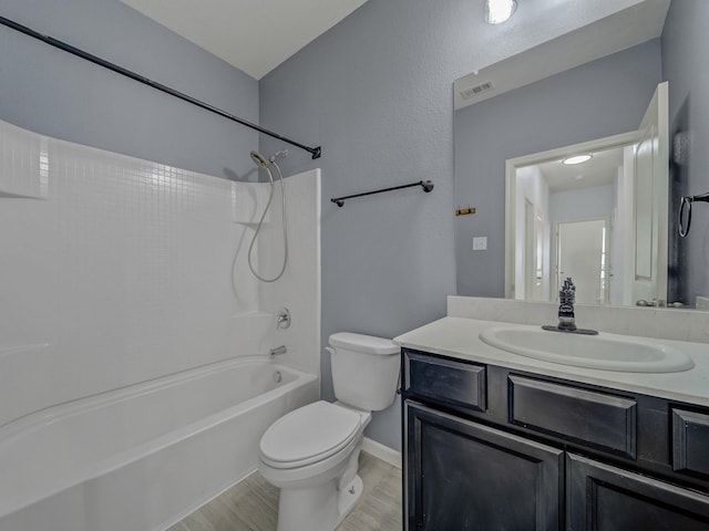 bathroom featuring toilet, shower / bathtub combination, visible vents, wood finished floors, and vanity